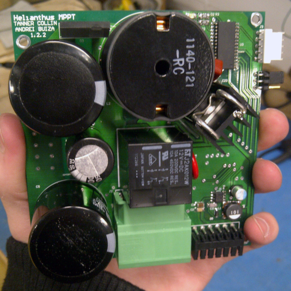 the MPPT device, a printed circuit board with bulky round electrical components held in my hand